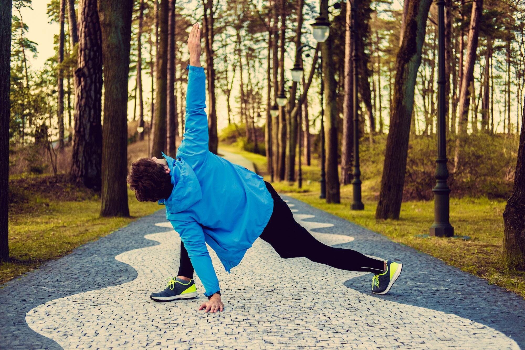 Flexible fitness man in a blue sports jacket.